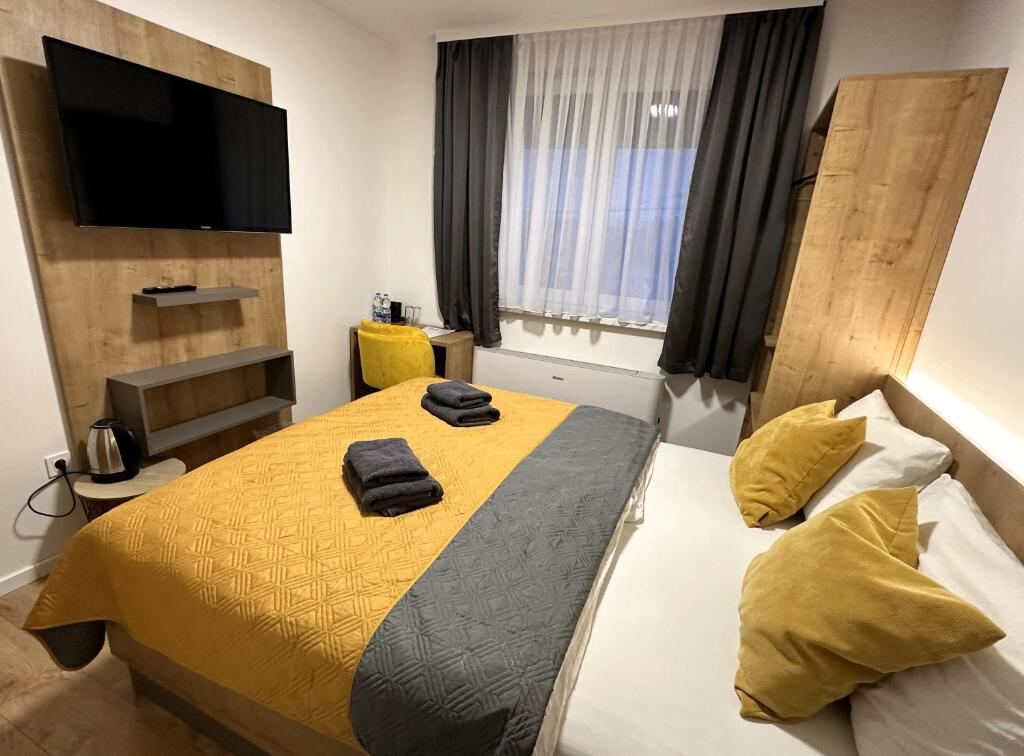 Room at RoomSB with a flat-screen TV