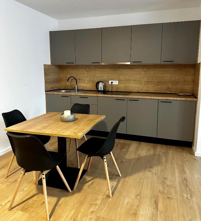 Apartment kitchen with dining table at RoomSB