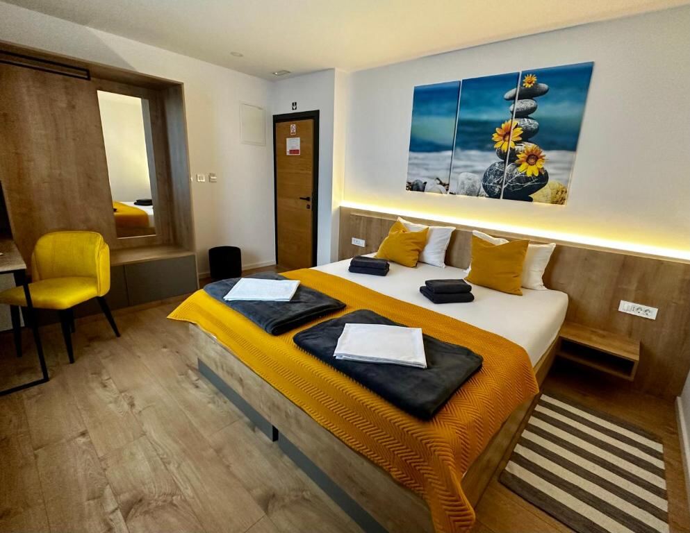Room at RoomSB with a large bed and mirror